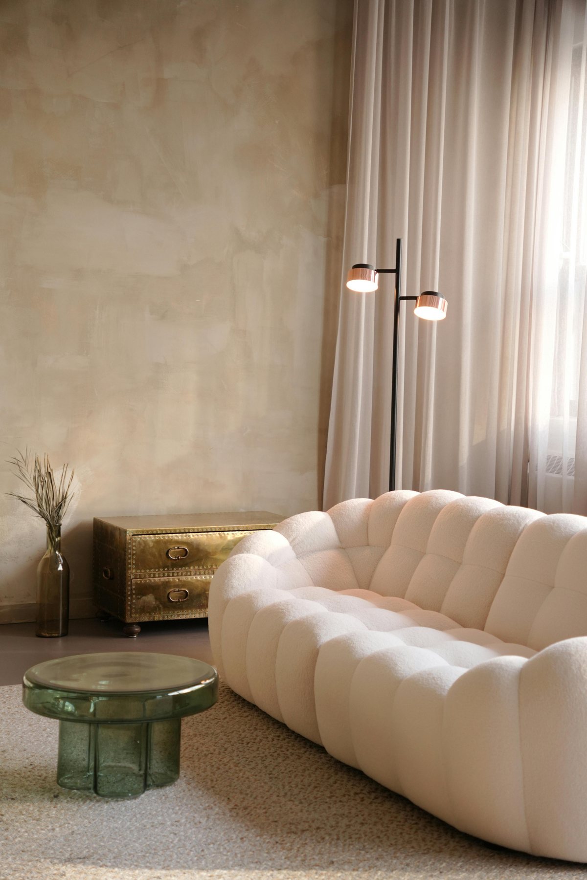 Sculpted sofa in a warm, textured interior
